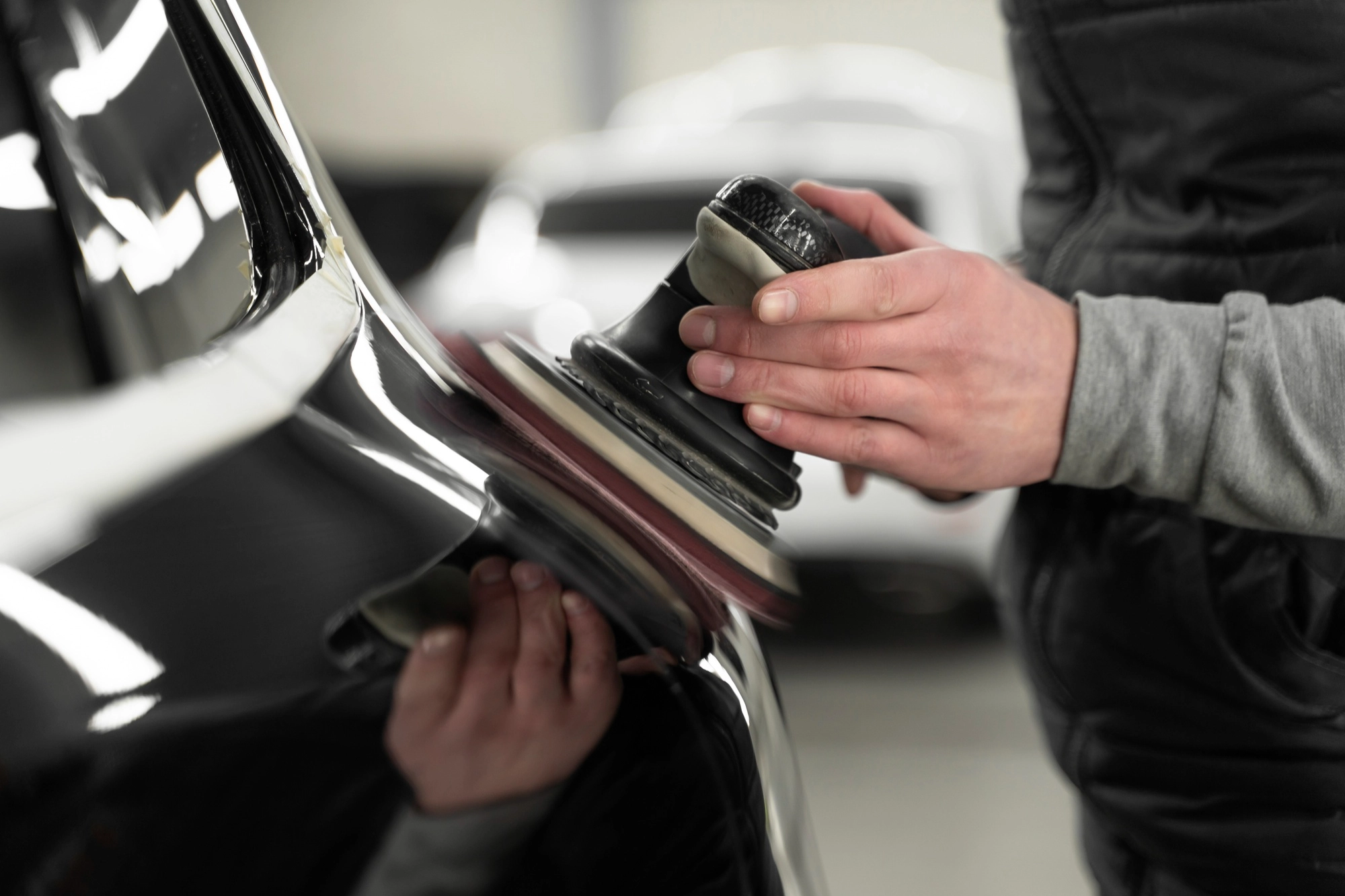 Paint protection film being applied to a car bonnet